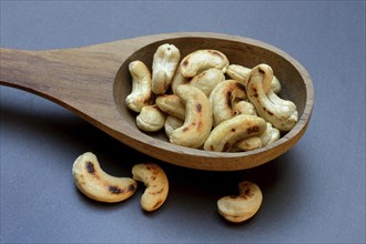 Cashew, roasted cashews in wooden ladle