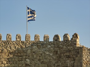 Venetian sea fortress, Koules, Morosini, battlements, Greek national flag, blue cloudless sky,