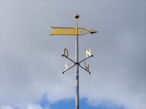 Metal wind arrow and wind chime for indicating cardinal points, north, south, east, west, Germany,