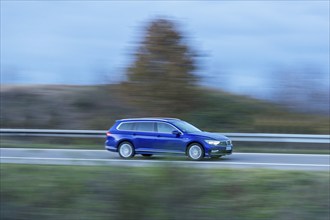 Blue VW Passat Variant driving on a country road, twilight, motion blur, Baden-Württemberg,