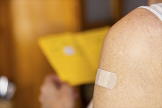 Woman vaccinated with a corona agent looks at her vaccination card