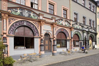 The square was given its distinctive shape in the 16th century by the town house and the