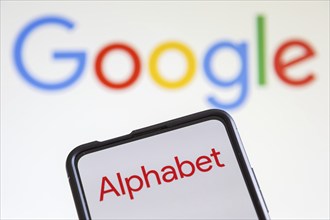 Google and Alphabet logo of the computer hardware software and search engine producer on a mobile