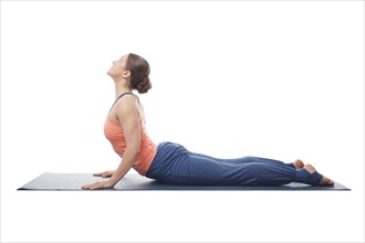 Beautiful sporty fit yogini woman practices yoga asana bhujangasana, cobra pose isolated on white