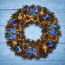 Christmas wreath on blue painted wooden background