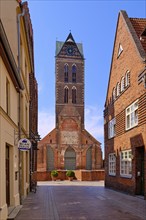 Empty coffin-maker's street and tower of the ruins of St. Mary's Church, Old Town Hanseatic City of