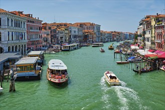 VENICE, ITALY, JULY 19, 2019: Grand Canal with boats, vaporetto and gondolas on sunset from Rialto