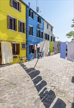 Laundry line with pieces of laundry, colourful houses, colourful house facades, alleys on the