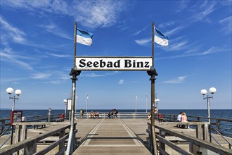 Pier with tourists and sign, inscription Seebad Binz, sunny weather, Rügen, Mecklenburg-Western