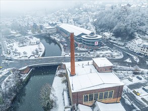 Aerial view of a snow-covered town with river and bridge in winter, Black Forest, Calw, Germany,