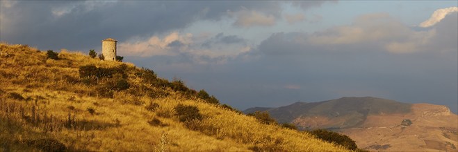 All around, panorama shot, evening light, autumn hill landscape, brown fields, dramatic cloudy sky,