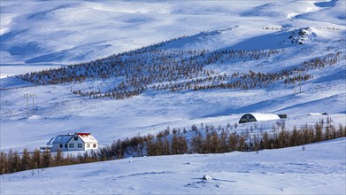 Farmhouse in snow-covered hilly landscape, near Akureyri, North Iceland Eyestra, Iceland, Europe