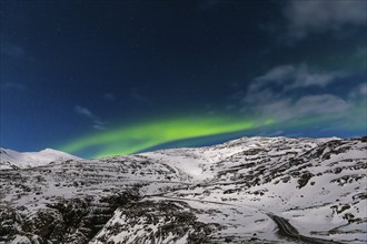 Northern Lights, Aurora Borealis, over snow-covered landscape at Skalafellsjökull, Sudurland,