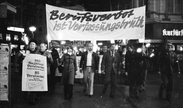 Nazi victims, some in concentration camp uniforms, demonstrated against the occupational bans