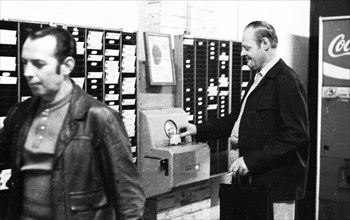 Workers and employees at the time clock of the Pohlschroeder company in Dortmund, Germany, on 01.08