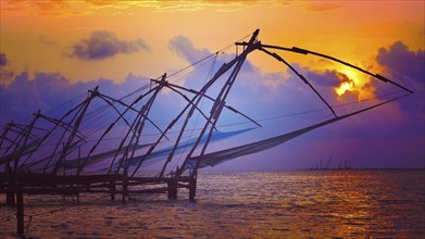 Panorama of Kochi tourist attraction, chinese fishnets on sunset with grunge texture overlaid. Fort