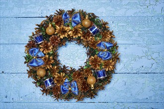 Christmas wreath on blue painted wooden background