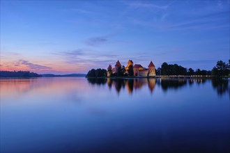 Trakai Island Castle in lake Galve illuminated in night, Lithuania, Europe