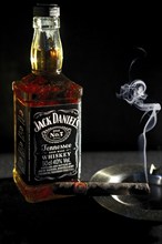 Minsk, Belarus, January 25, 2016: Bottle of Jack Daniel's near ashtray with smoking cigar, Europe