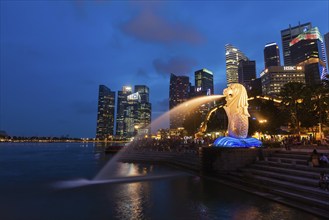 SINGAPORE, JANUARY 1, 2014: Night view of Singapore Merlion at Marina Bay against Singapore skyline