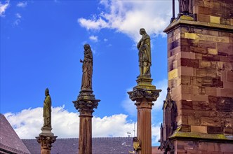 Plague pillars with patron saints in front of the main portal of Freiburg Cathedral on Münsterplatz