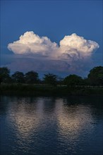 Illuminated cloud over the Magdalena river, Unesco world heritage site, Mompox, Colombia, South