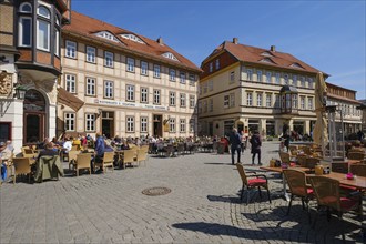 Tourists sitting outside a restaurant on the market square, half-timbered houses, Wernigerode, Harz