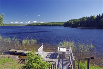 Idyllic white bench by a lake, bathing opportunity, Dalsland Canal, Bengtfors, Dalsland, Västra