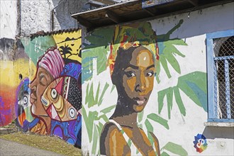 Colourful Garifuna graffiti, wall paintings, street art showing Black Caribs in the town