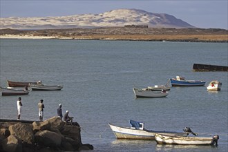 Fishermen and little fishing boats in the small harbour of Sal Rei on the island Boa Vista, Cape