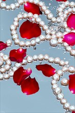 Pearl necklace in the water with splashes, drops and reflections, AI generated