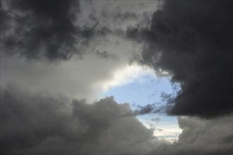 A break in thick layer of clouds of thundery sky after thunderstorm