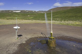 Shower and sink with hot water at Krafla, volcanic caldera in the Myvatn Geothermal Area in summer,