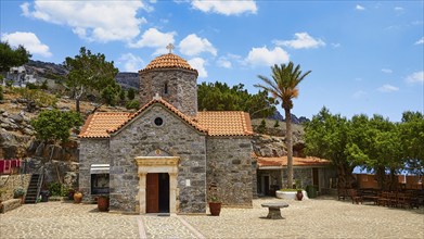 Church, stone building, red tiled roof, dome, palm tree, forecourt, Koudouma, Orthodox monastery,