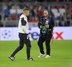 TV camera watches Joshua Kimmich FC Bayern Munich FCB (06) taking the pitch in front of the match,