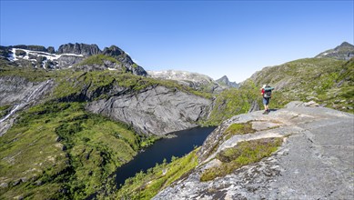 Mountaineers on the hiking trail to Munkebu hut, view of lake Tridalsvatnet and mountain landscape,