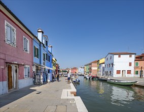 Colourful houses on the canal with reflection, Canal with boats and colourful house facades, Burano