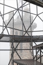 Rye, Colorado, Towers of Bishop Castle on a foggy morning. The Castle is an elaborate stone and