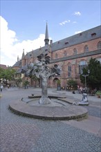 Fountain of Paradise by Gernot Rumpf 1973 at the Kartoffelmarkt with baroque collegiate church St.