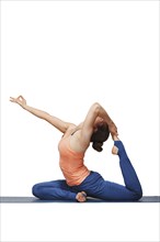 Woman doing Hatha yoga asana Eka pada rajakapotasana, one-legged king pigeon pose isolated