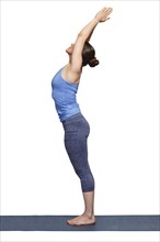 Woman doing Hatha Yoga asana Tadasana, Mountain pose with stretched hands isolated