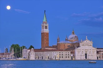 Basilica San Giorgio Maggiore Church seen across the Venice lagoon with full moon. Venice, Italy,