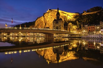 Night view of Dinant town, Collegiate Church of Notre Dame de Dinant over River Meuse and Pont