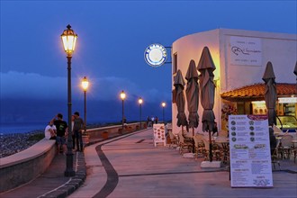 Coastal promenade, young passers-by, lanterns, night blue sky, night shots, evening mood, Lingua,