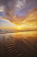 Atlantic ocean sunset with surging waves at Fonte da Telha beach, Costa da Caparica, Portugal,