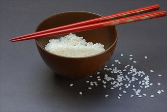 Rice, white rice in bowl with chopsticks, uncooked