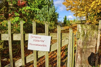 No Trespassing Private Property, sign on a garden gate made of wooden slats