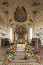 Interior view with altar of baroque magnificent St. Martin Church during harvest festival, harvest