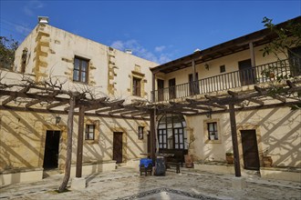 Inner courtyard, grape arbours, building over corner, Panagias, Odigitrias, Gonias, Orthodox