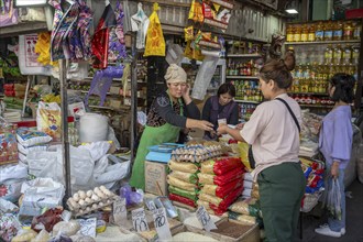 Woman selling food in a market at Osh Bazaar, Bishkek, Kyrgyzstan, Asia